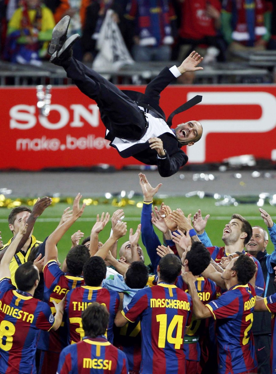 106058-barcelonas-manager-pep-guardiola-is-thrown-in-the-air-by-his-players-a
